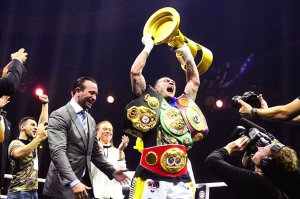   Alexander Usik holds the Mohammed Ali trophy. On this - four belts of world champion 